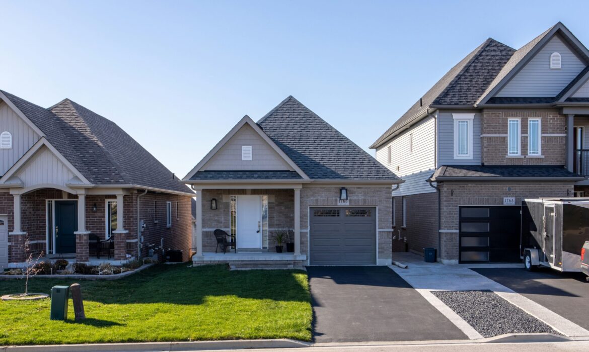 Small grey brick home in a subdivision.