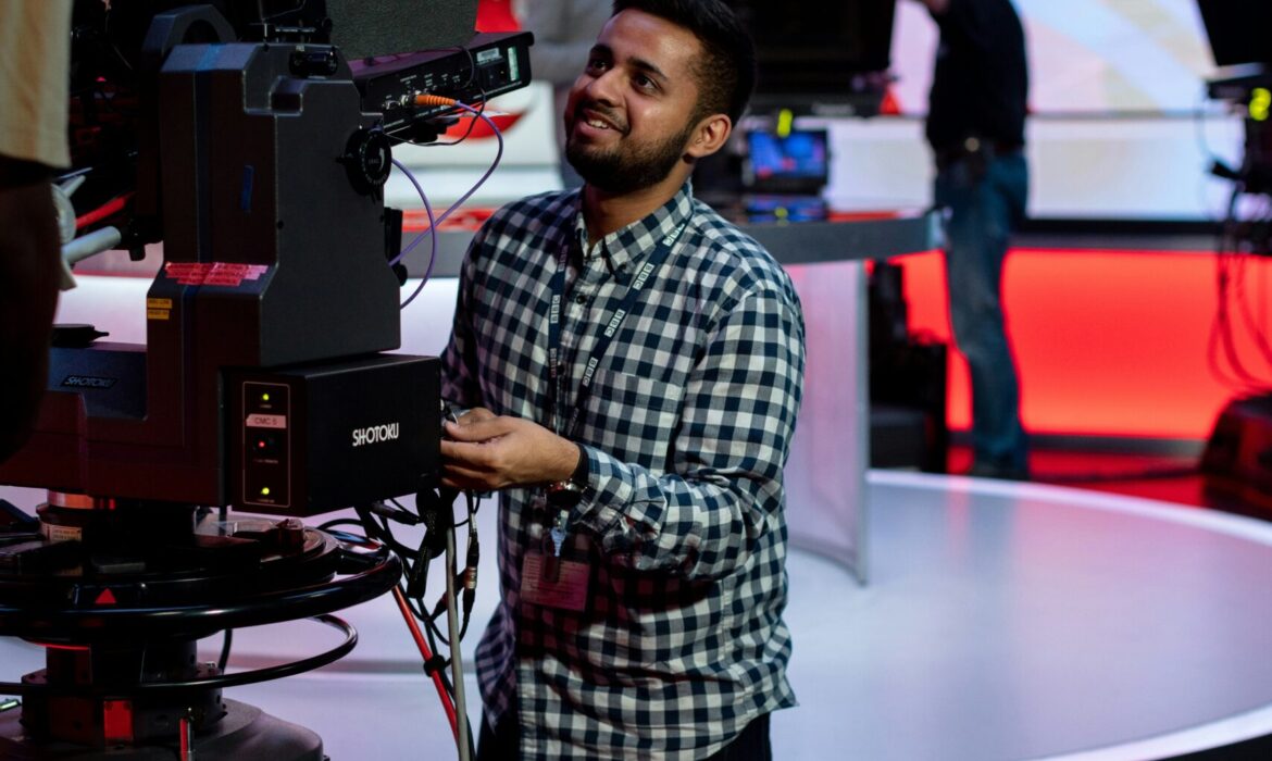 Male broadcast engineer works in studio